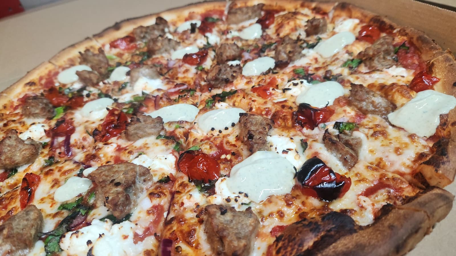 Urban Pizza topped with meatballs, mozzarella and roasted vegetables